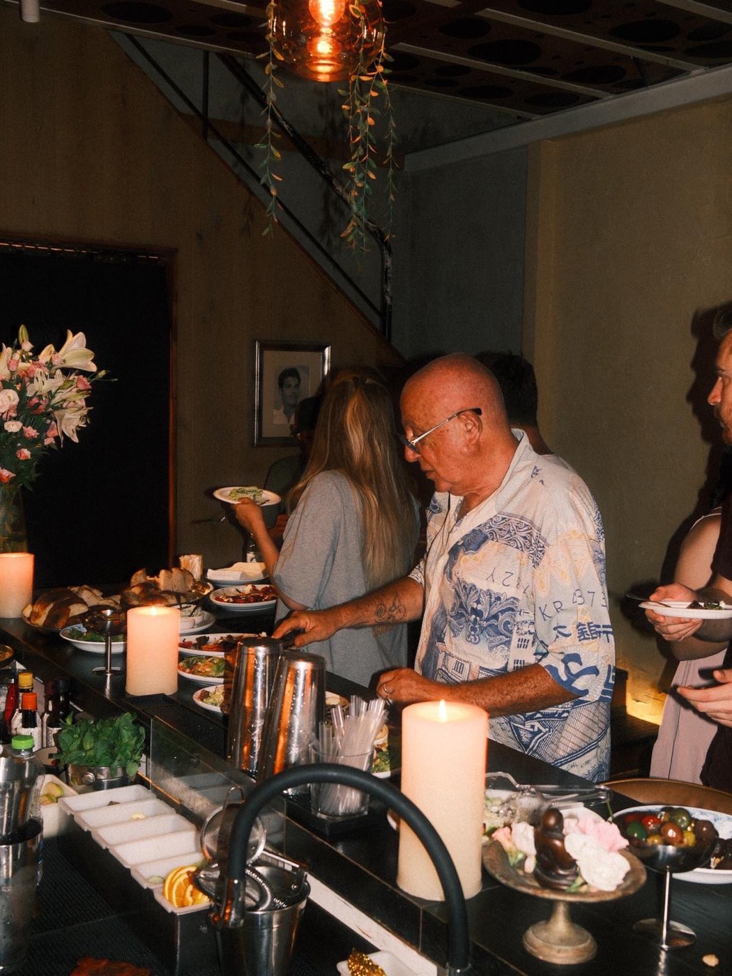 Guests at the bar at Ezra by candlelight
